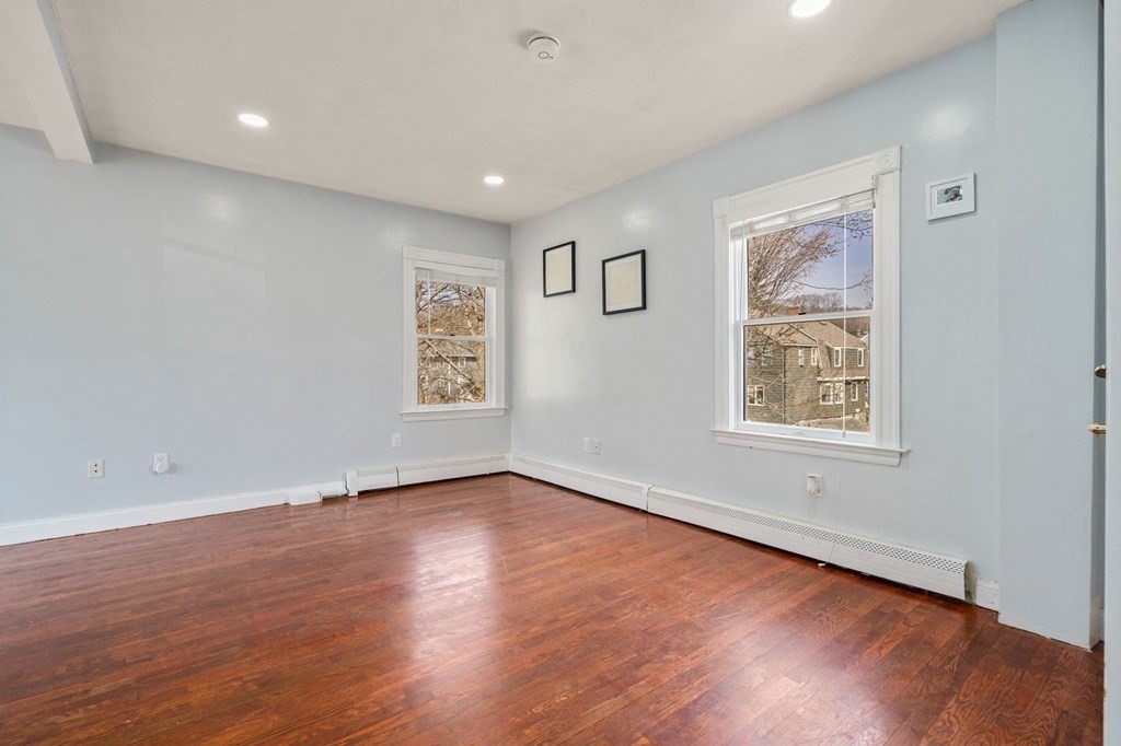 83 Cedar Street Wakefield, MA 01880 - Photo 13 of 36 an empty room with wooden floor and windows