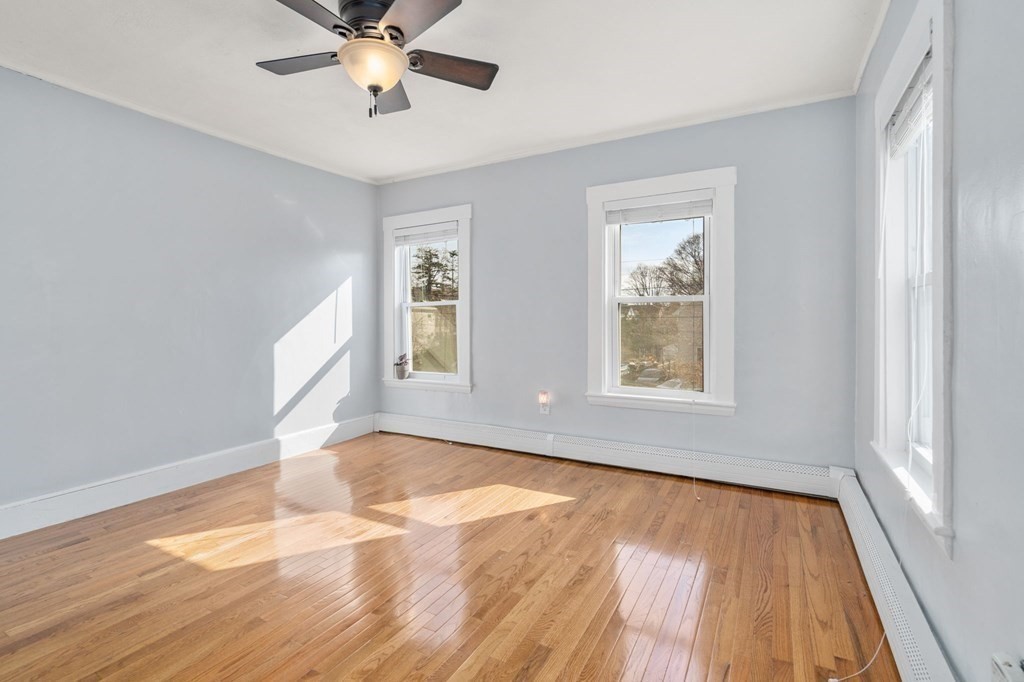 83 Cedar Street Wakefield, MA 01880 - Photo 15 of 36 a view of an empty room with wooden floor and a window