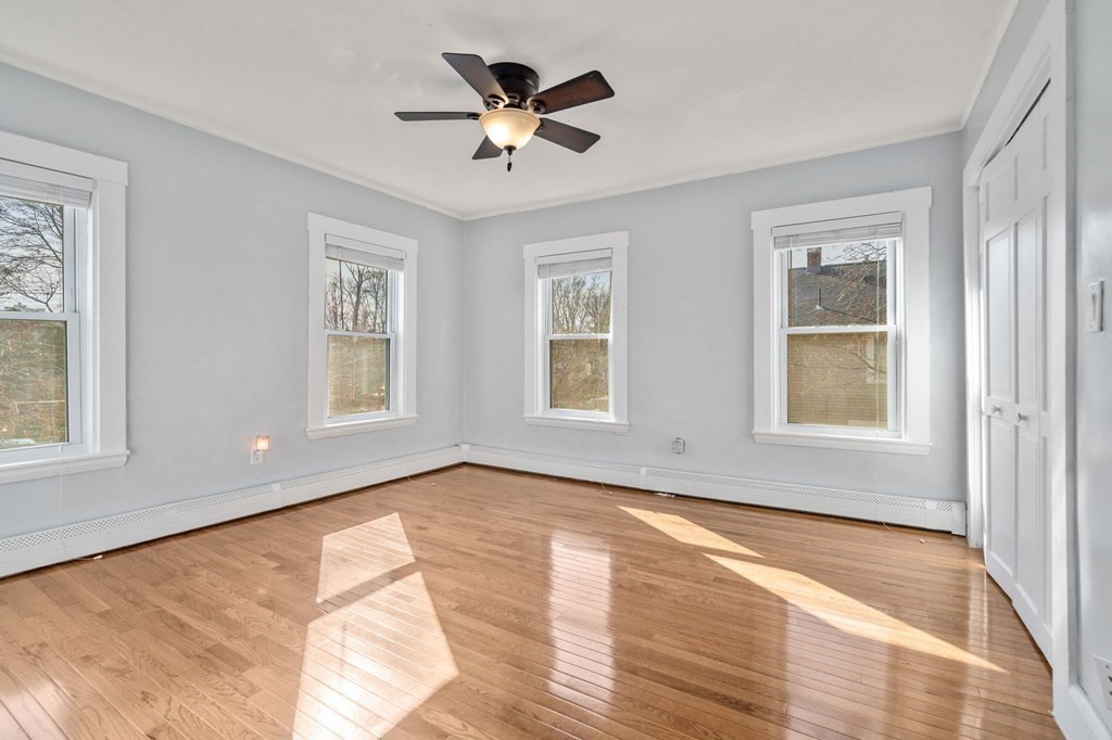 83 Cedar Street Wakefield, MA 01880 - Photo 16 of 36 a view of an empty room with a window and wooden floor