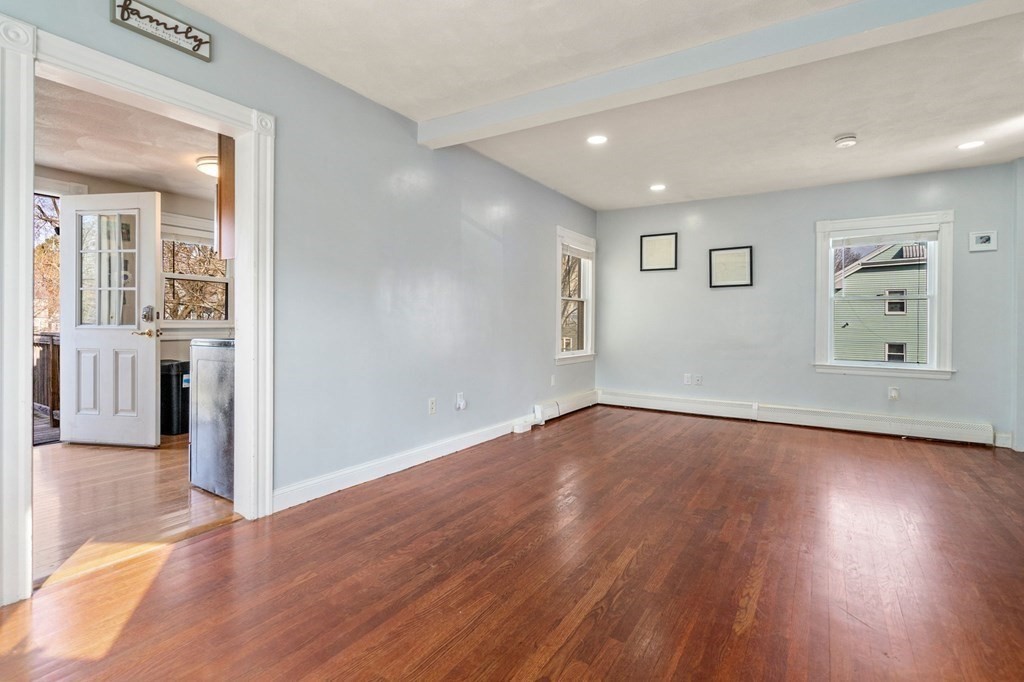 83 Cedar Street Wakefield, MA 01880 - Photo 18 of 36 wooden floor in an empty room with a window