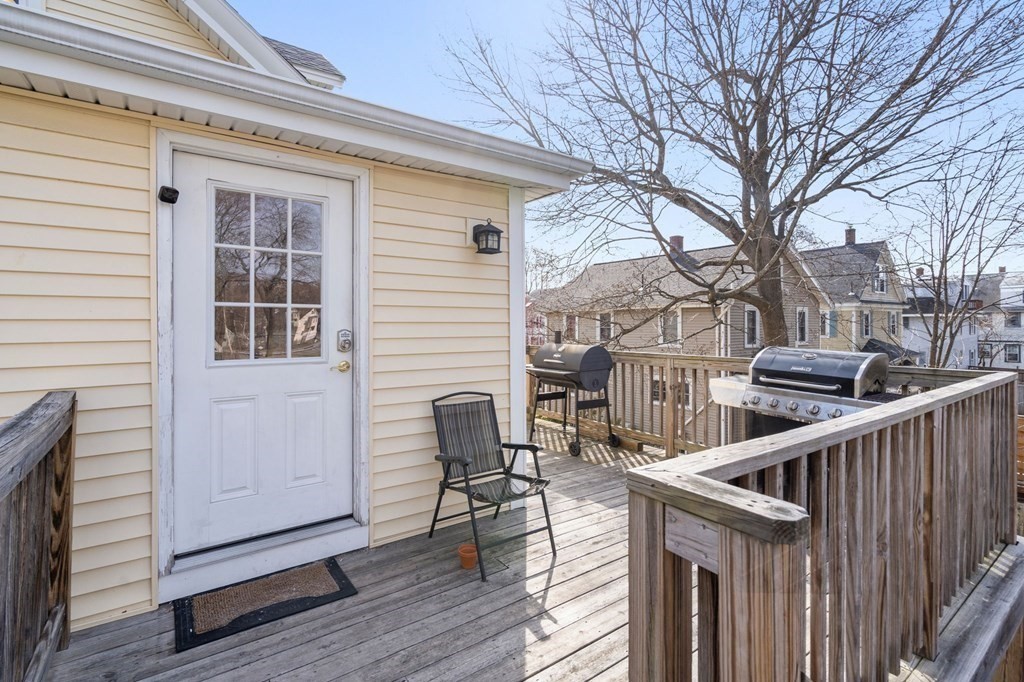 83 Cedar Street Wakefield, MA 01880 - Photo 19 of 36 a balcony with table and chairs and wooden floor