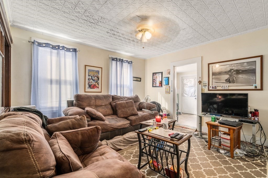 83 Cedar Street Wakefield, MA 01880 - Photo 24 of 36 a living room with furniture a flat screen tv and a window