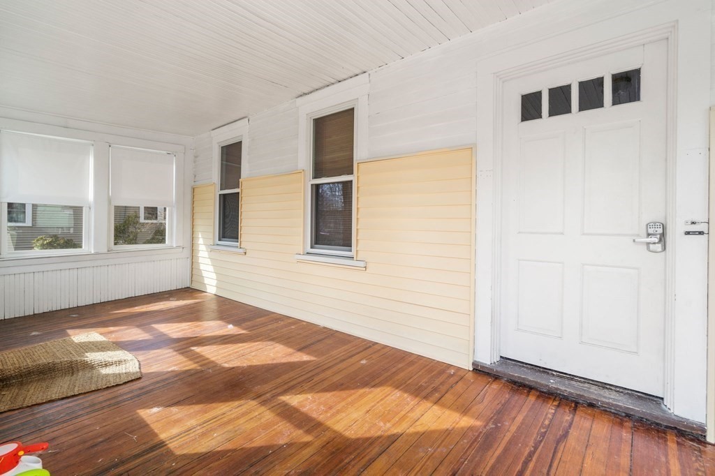 83 Cedar Street Wakefield, MA 01880 - Photo 27 of 36 a view of an empty room with window and wooden floor