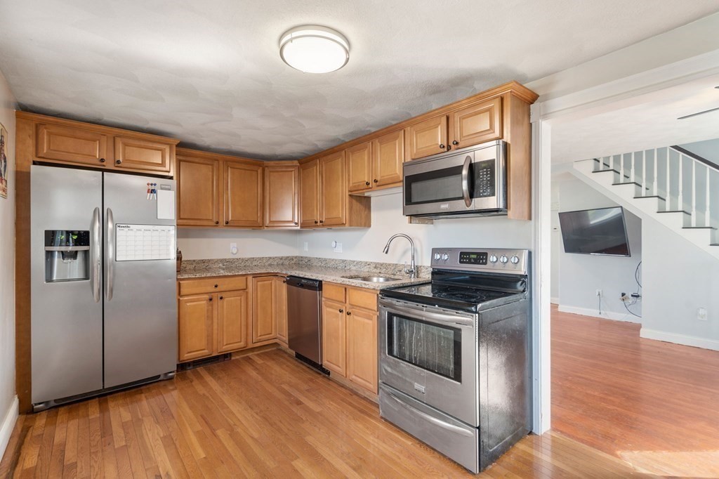83 Cedar Street Wakefield, MA 01880 - Photo 3 of 36 a kitchen with stainless steel appliances granite countertop a stove a sink and a microwave