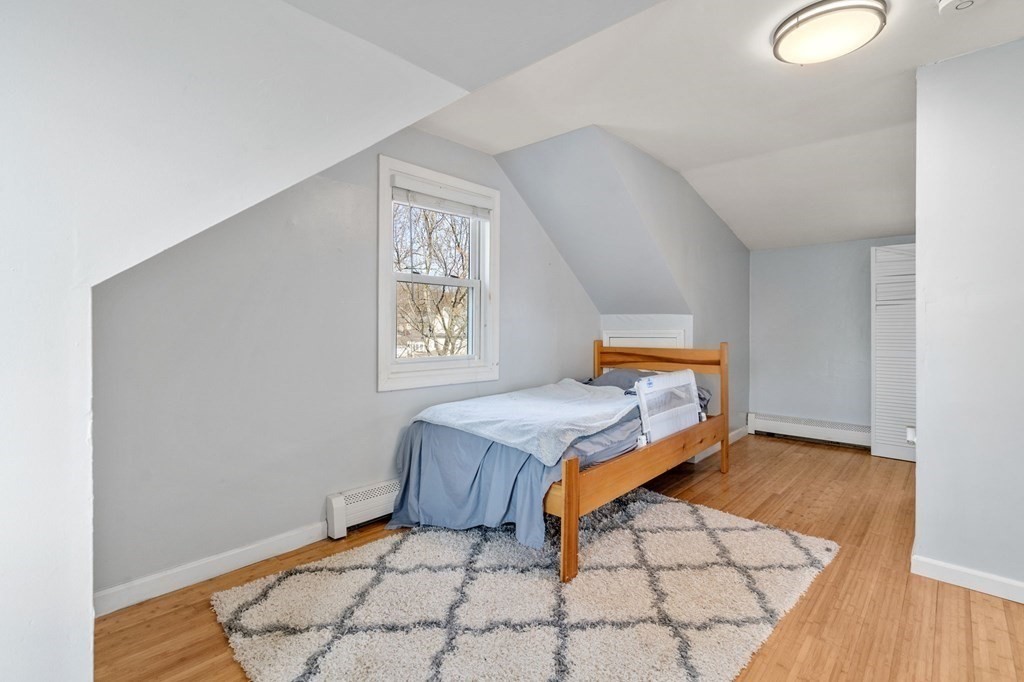 83 Cedar Street Wakefield, MA 01880 - Photo 10 of 36 a bedroom with a bed and a window