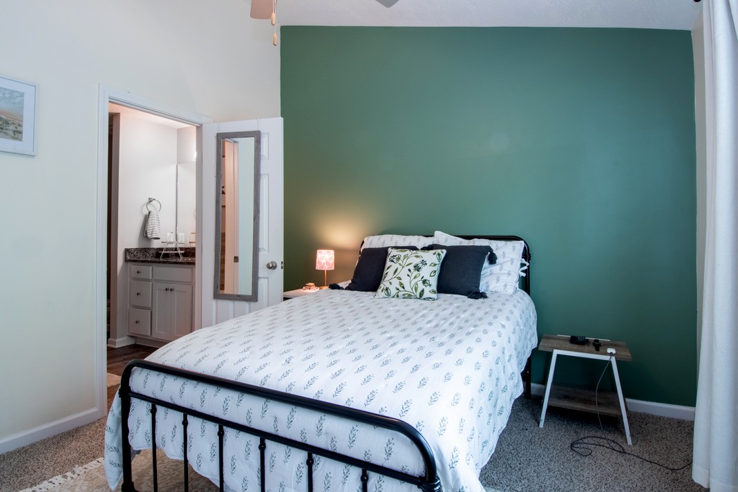 1382 Rural Hill Road, Unit 316 Antioch, TN 37013 - Photo 13 of 23 a bedroom with a bed a table and chair