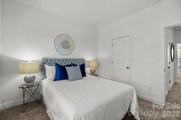 a bedroom with a bed and a lamp