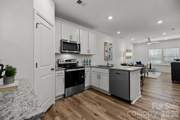 a kitchen with a sink cabinets and stainless steel appliances