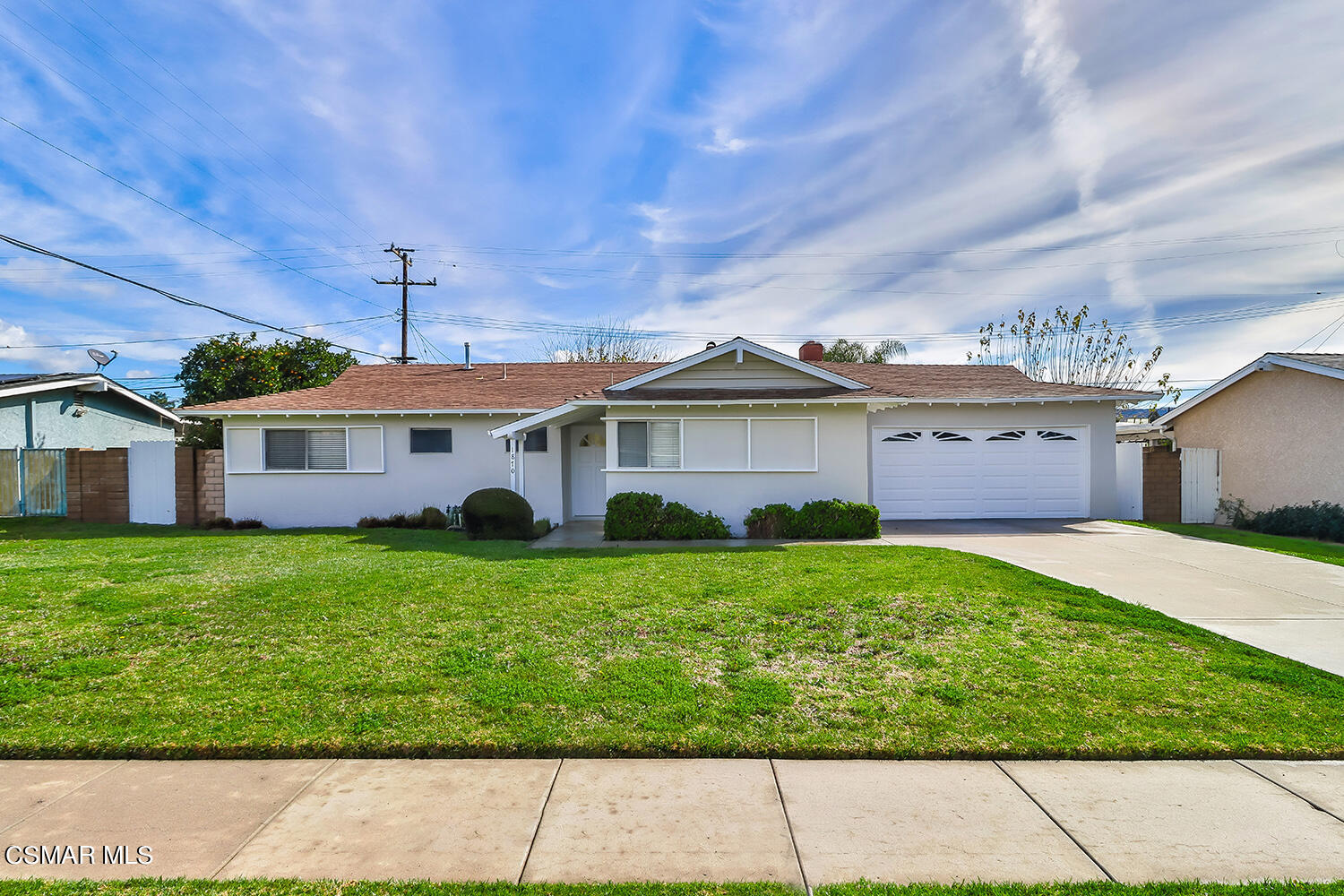 1870 Burch Avenue Simi Valley, CA 93063 - Photo 3 of 20 a front view of a house with a yard and garage