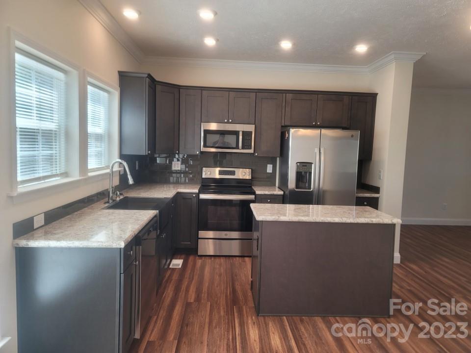 37 Hampton Heights Road Canton, NC 28716 - Photo 3 of 15 a kitchen with kitchen island a counter top space appliances and a window