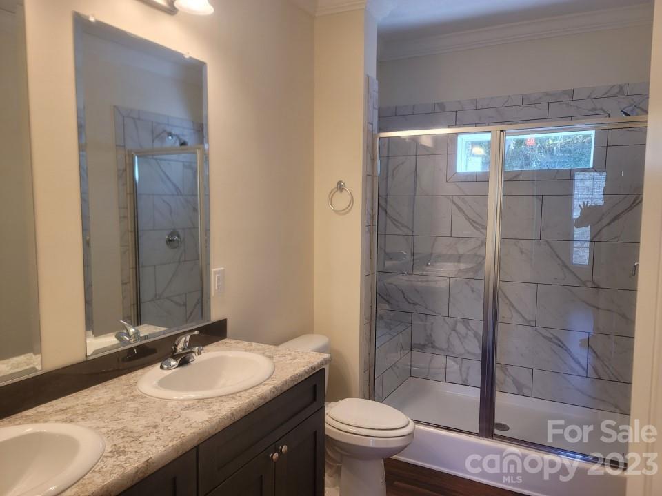 37 Hampton Heights Road Canton, NC 28716 - Photo 9 of 15 a bathroom with a granite countertop sink a toilet a mirror and shower
