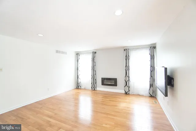 a living room with a flat screen tv and a fireplace