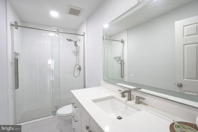 a bathroom with a sink mirror and vanity