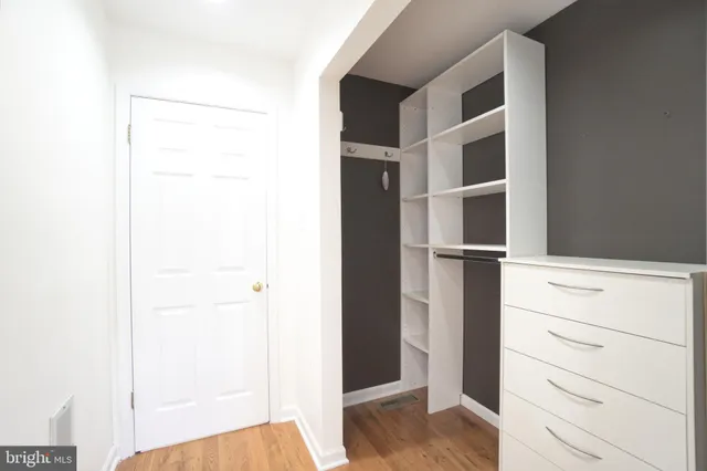 a view of walk in closet with empty racks