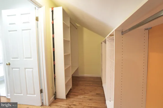 a view of an entryway with wooden floor and a rug