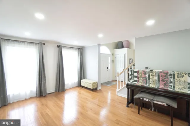 a room with lots of wooden furniture and a window