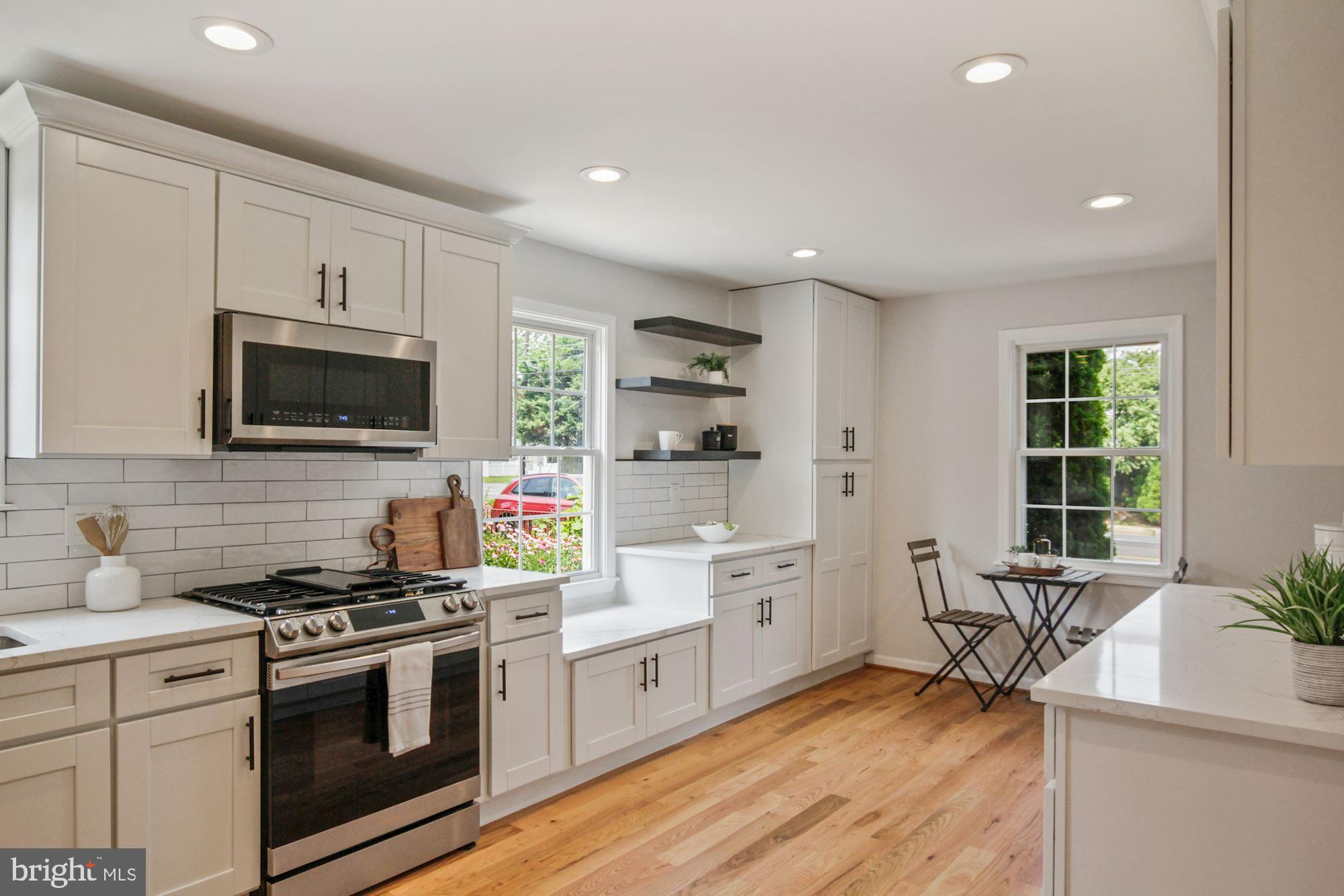 8112 Old Georgetown Road Bethesda, MD 20814 - Photo 12 of 51 a kitchen with stainless steel appliances a stove a sink and a microwave