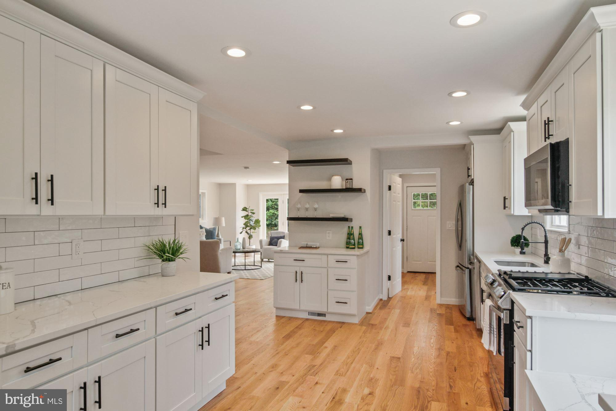 8112 Old Georgetown Road Bethesda, MD 20814 - Photo 16 of 51 a kitchen with white cabinets and stainless steel appliances