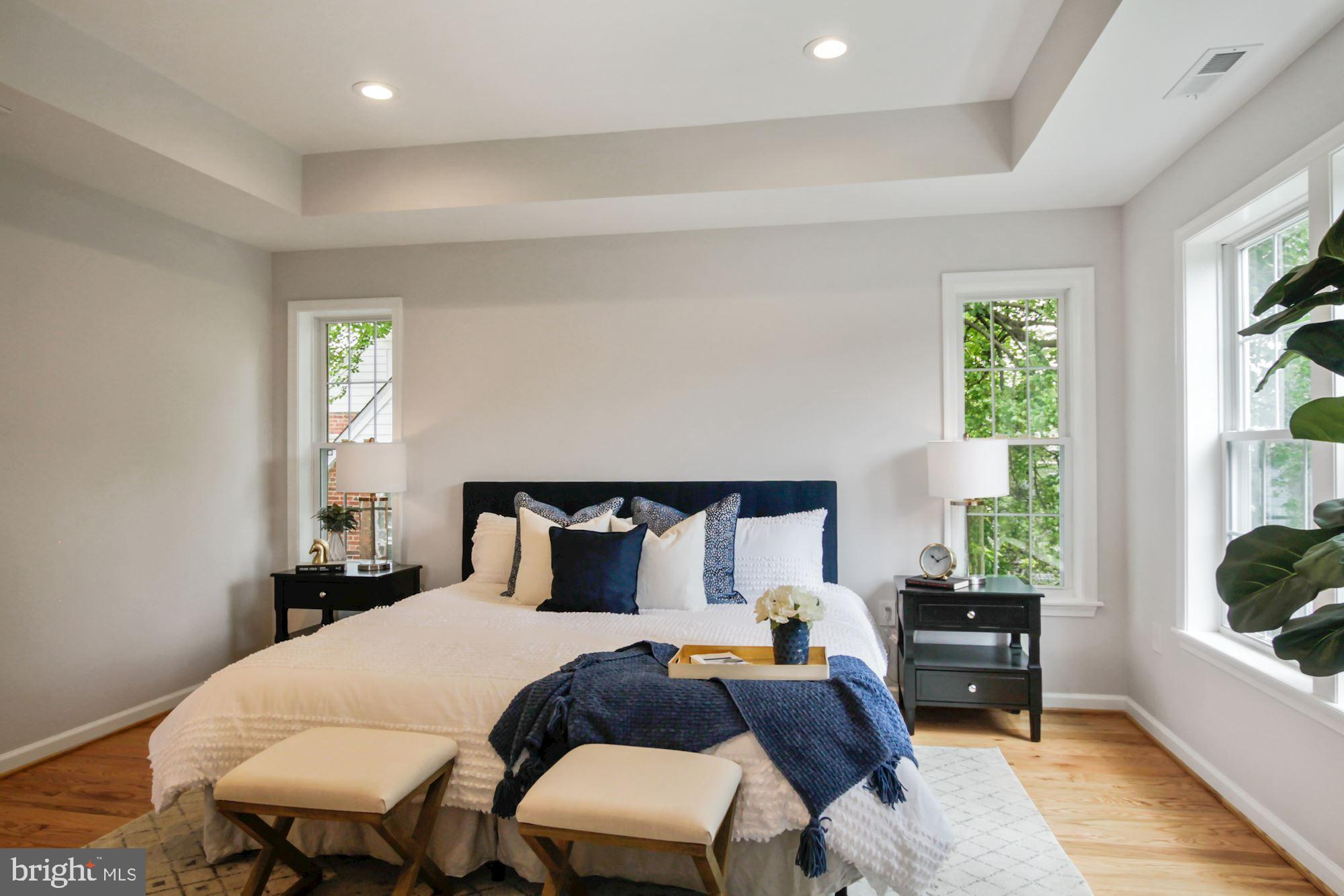 8112 Old Georgetown Road Bethesda, MD 20814 - Photo 22 of 51 a bedroom with a bed and wooden floor