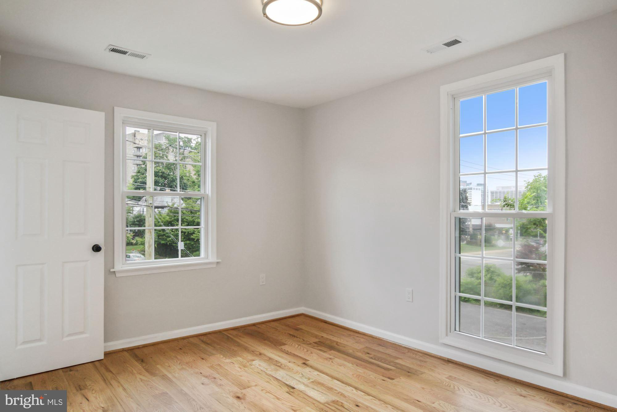 8112 Old Georgetown Road Bethesda, MD 20814 - Photo 31 of 51 an empty room with wooden floor and windows