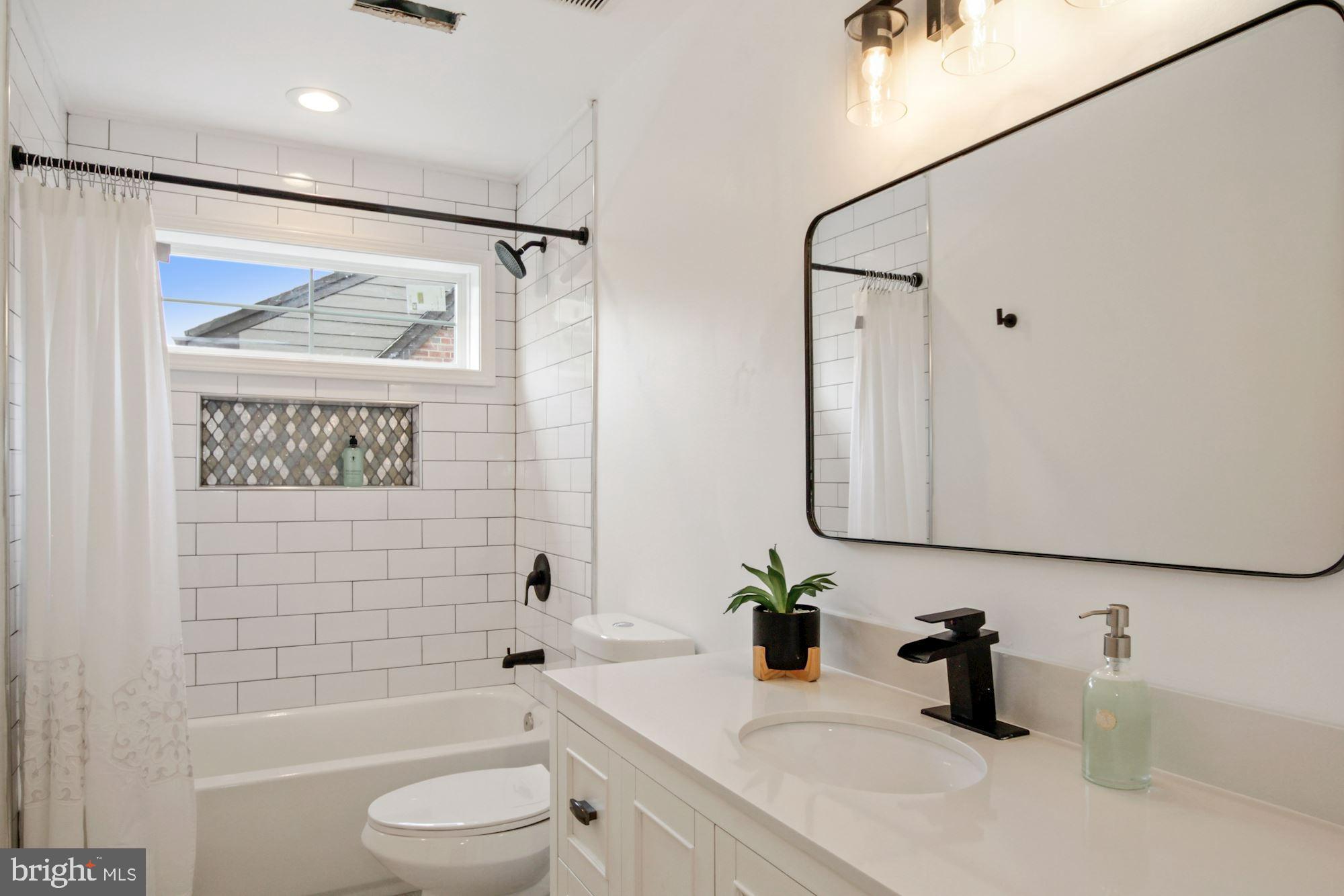 8112 Old Georgetown Road Bethesda, MD 20814 - Photo 33 of 51 a bathroom with a sink a toilet and shower