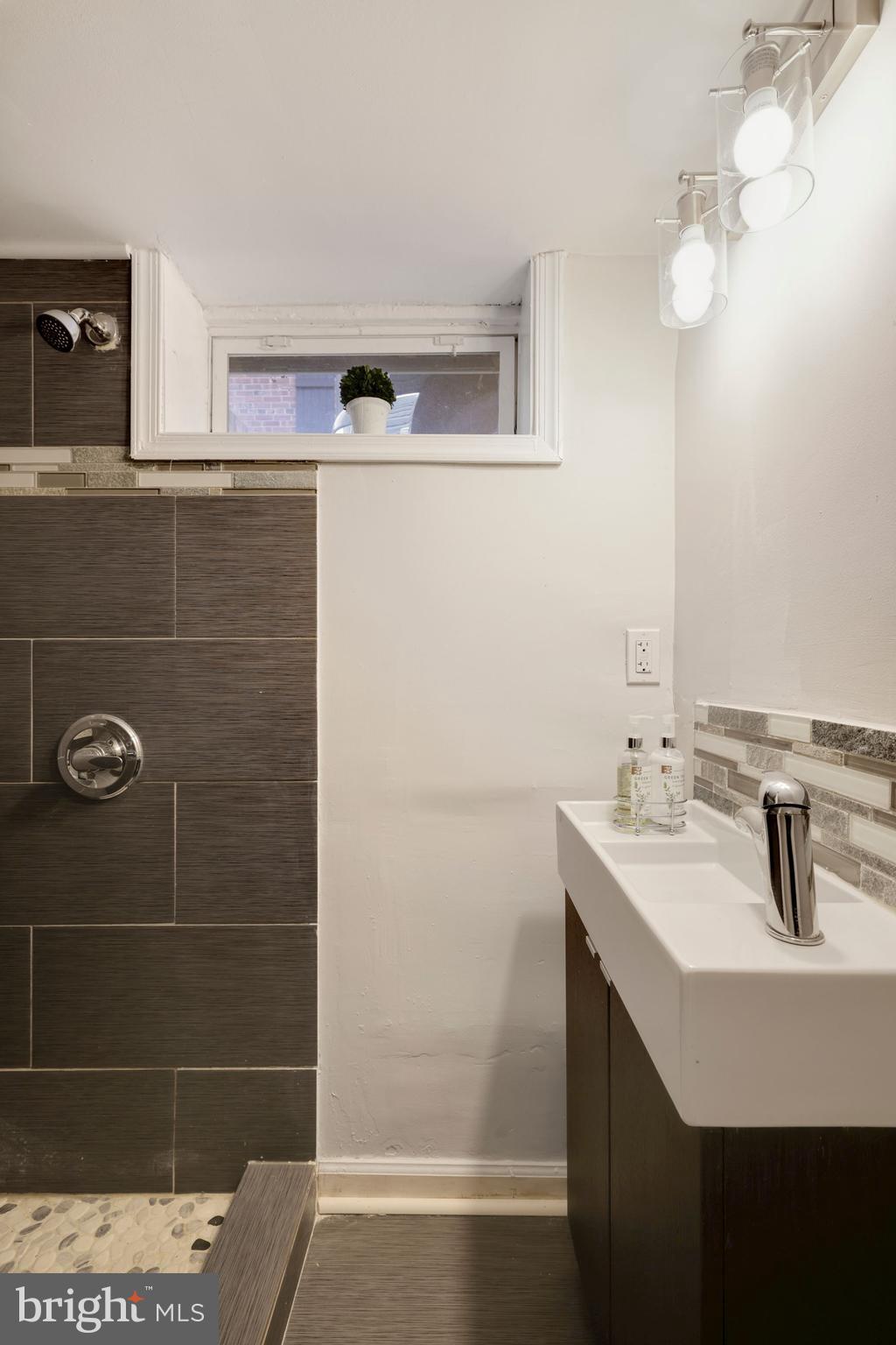 8112 Old Georgetown Road Bethesda, MD 20814 - Photo 41 of 51 a bathroom with a sink and a mirror