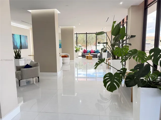 a view of living room with furniture and a potted plant