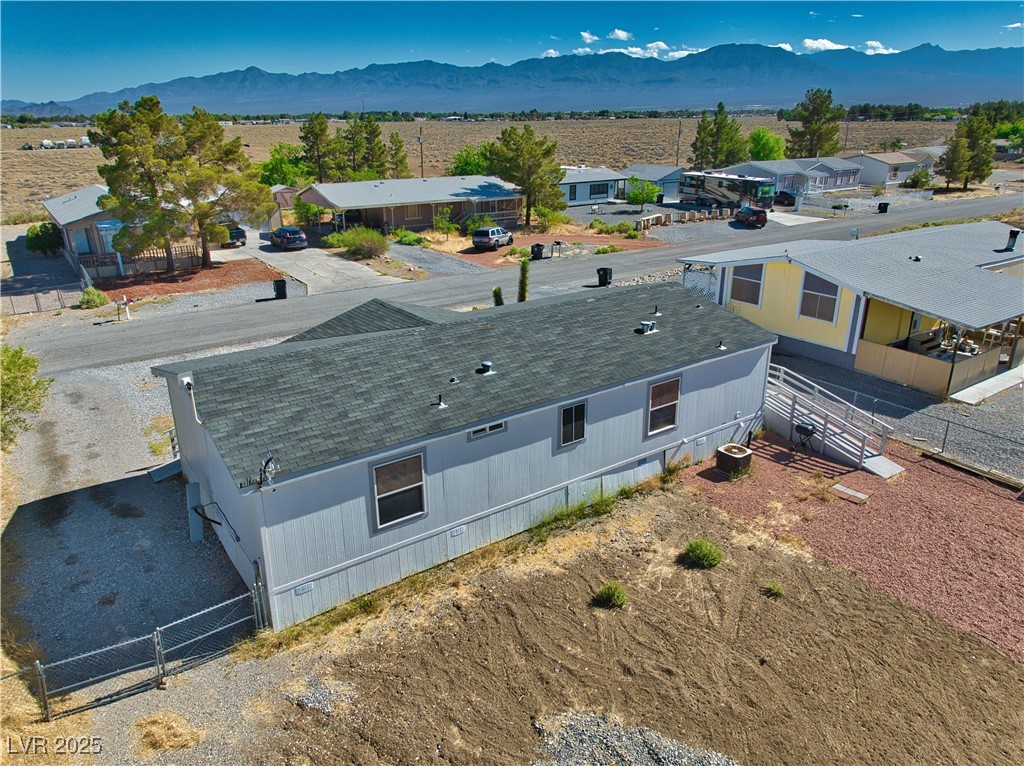 2891 Rio Rico Drive Pahrump, NV 89048 - Photo 24 of 45 Aerial perspective of suburban area with a mountain backdrop