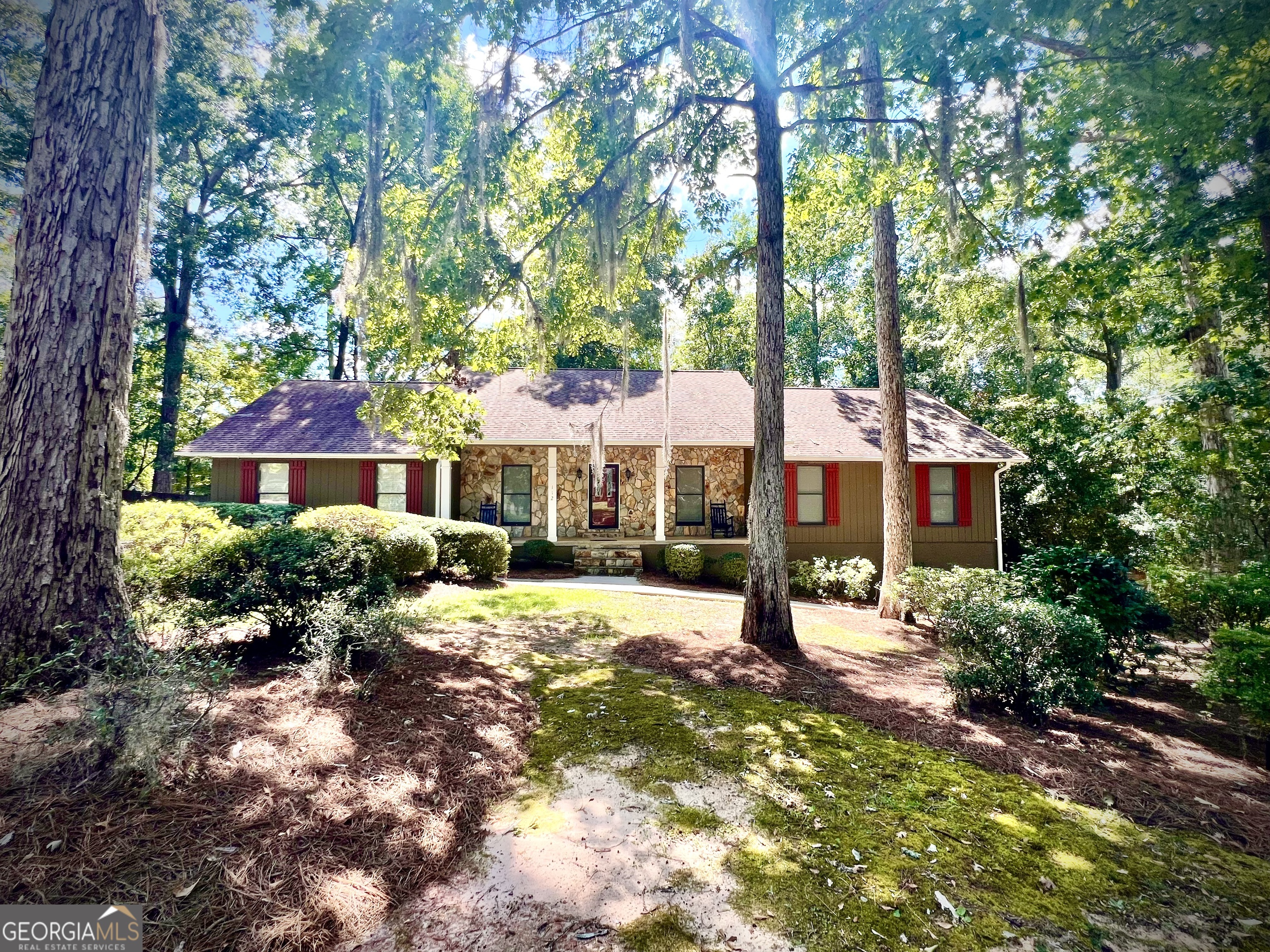 a front view of a house with yard and green space