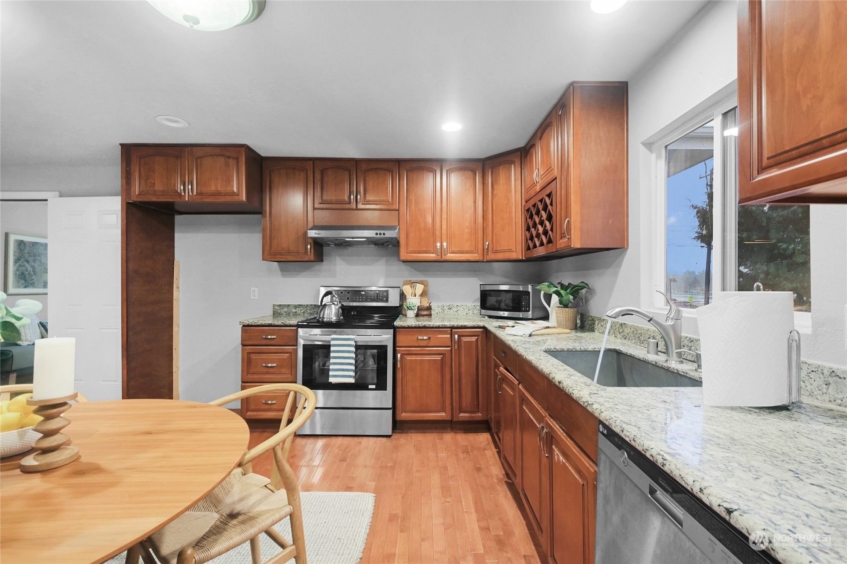 428 Southwest 124th Street Seattle, WA 98146 - Photo 12 of 28 a kitchen with stainless steel appliances granite countertop a sink dishwasher stove refrigerator and cabinets