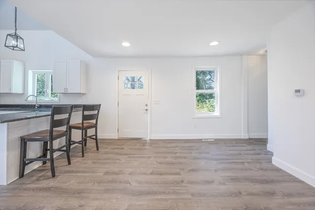 a view of a dining room with furniture and window