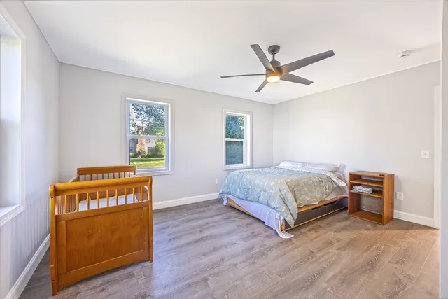 a bedroom with a bed and wooden floor