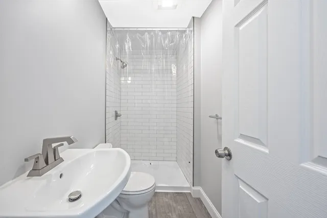 a bathroom with a sink toilet and shower