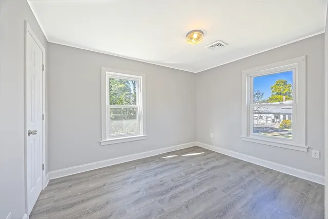 wooden floor in an empty room with a window