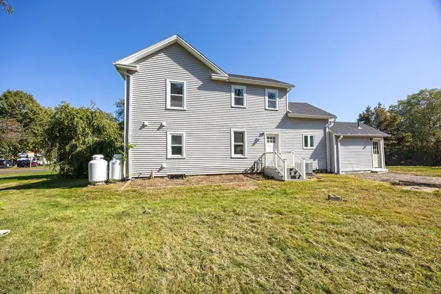 a front view of a house with a garden and yard