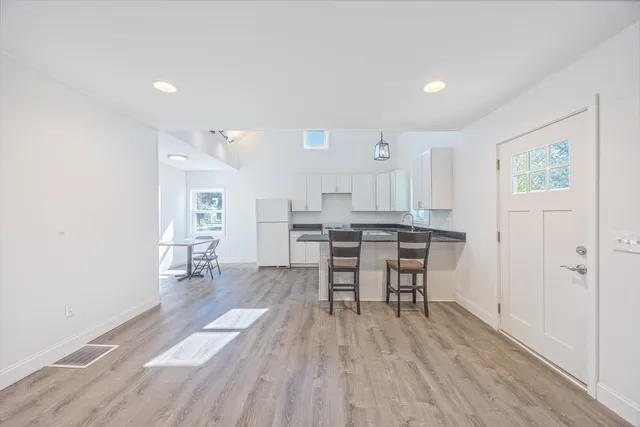 a view of a kitchen with dining table and chairs