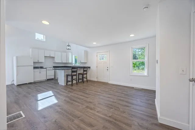 a kitchen with stainless steel appliances granite countertop a refrigerator and a stove top oven