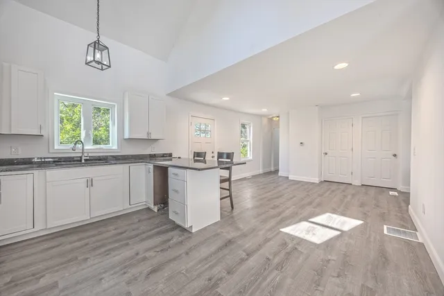 a open kitchen with a white cabinets and window