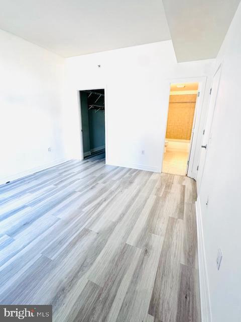 2120 Vermont Avenue Northwest, Unit 207 Washington, DC 20001 - Photo 11 of 32 a view of a room with wooden floor and a ceiling fan