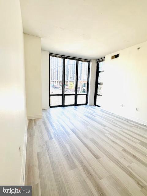 2120 Vermont Avenue Northwest, Unit 207 Washington, DC 20001 - Photo 5 of 32 a view of empty room with wooden floor and fan