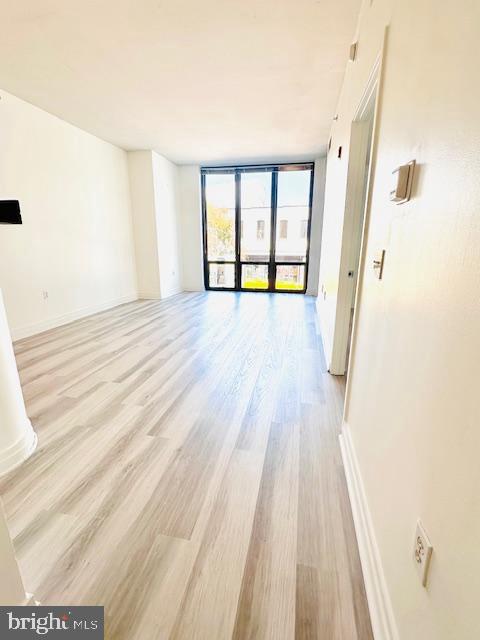 2120 Vermont Avenue Northwest, Unit 207 Washington, DC 20001 - Photo 6 of 32 a view of a room with wooden floor and a window