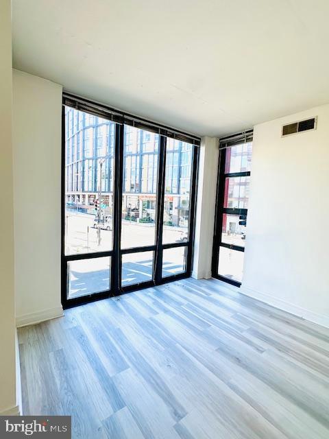 2120 Vermont Avenue Northwest, Unit 207 Washington, DC 20001 - Photo 7 of 32 wooden floor in an empty room with a window