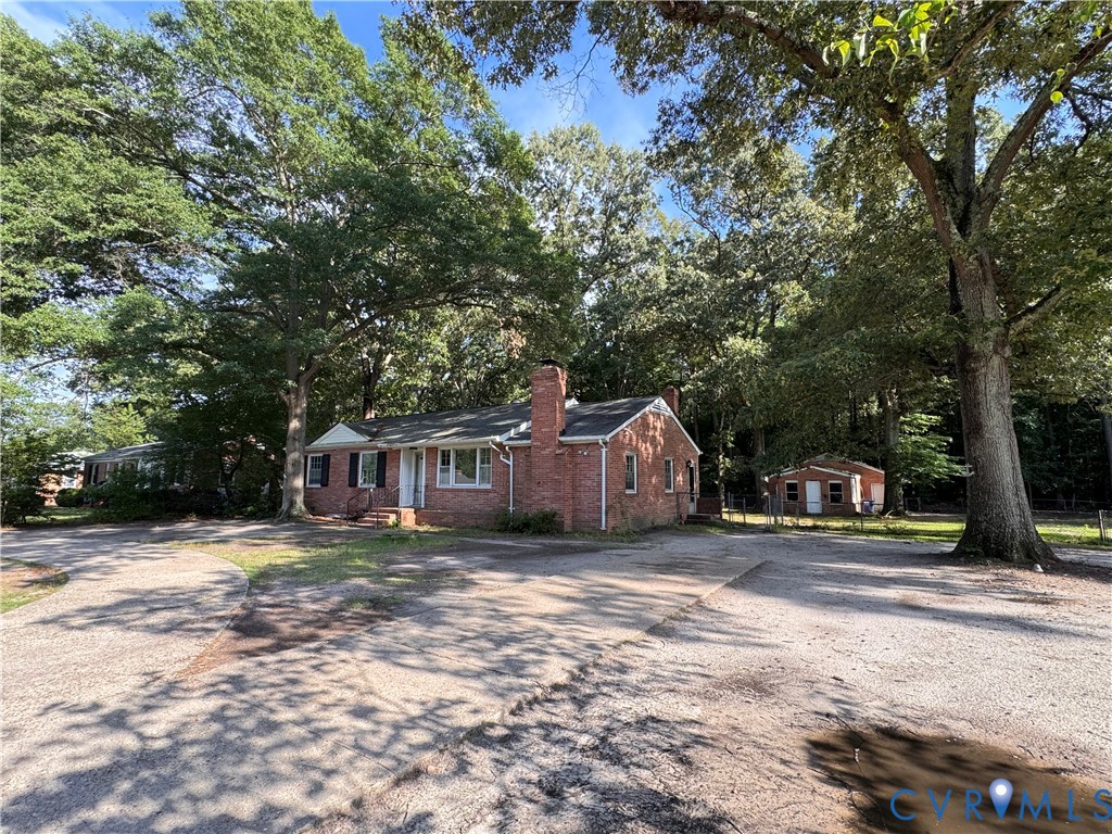 7019 Fairpines Road Richmond, VA 23234 - Photo 3 of 18 Brick ranch-style home featuring a prominent chimn
