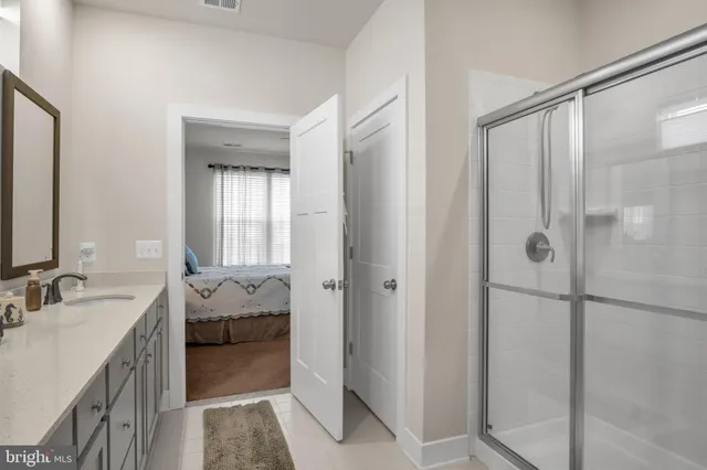 a bathroom with a tub sink and mirror