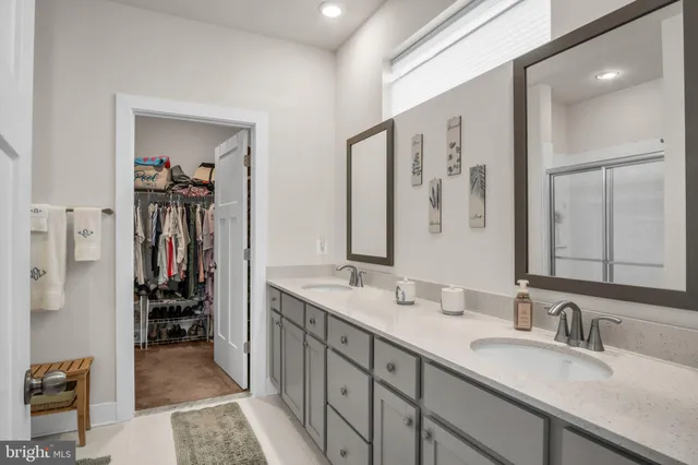 a en suite bathroom with double vanity sinks and a mirror