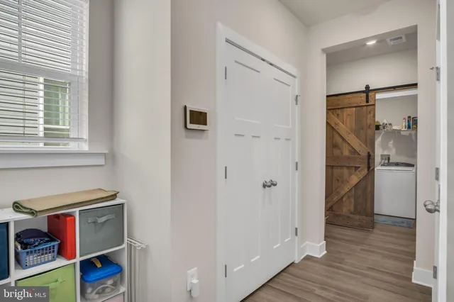 a very nice looking room with wooden floor and a bathroom
