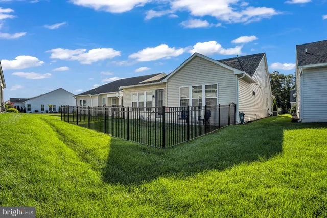 a front view of a house with a garden and plants