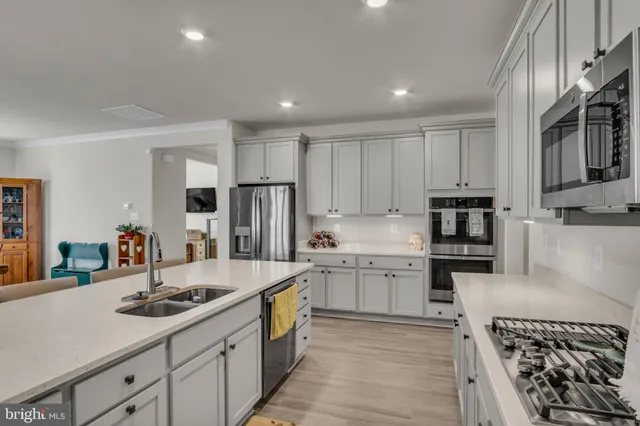 a kitchen with a sink stove and refrigerator