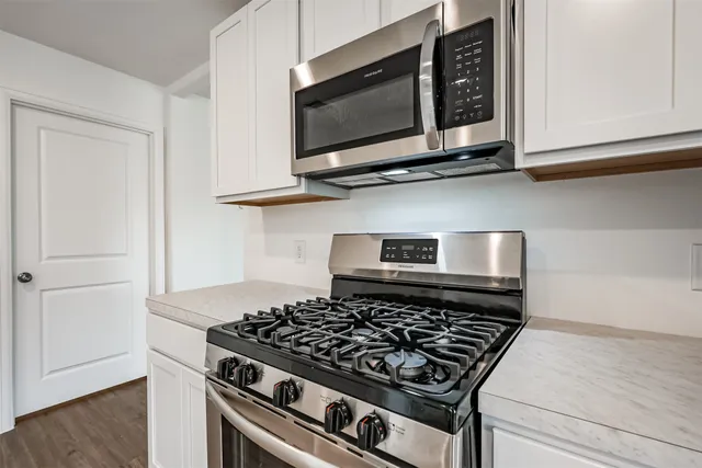 a stove top oven sitting inside of a kitchen