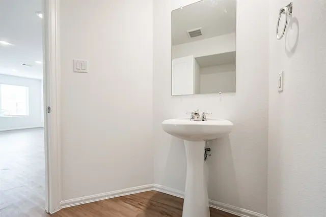 a bathroom with a sink a mirror and a shower